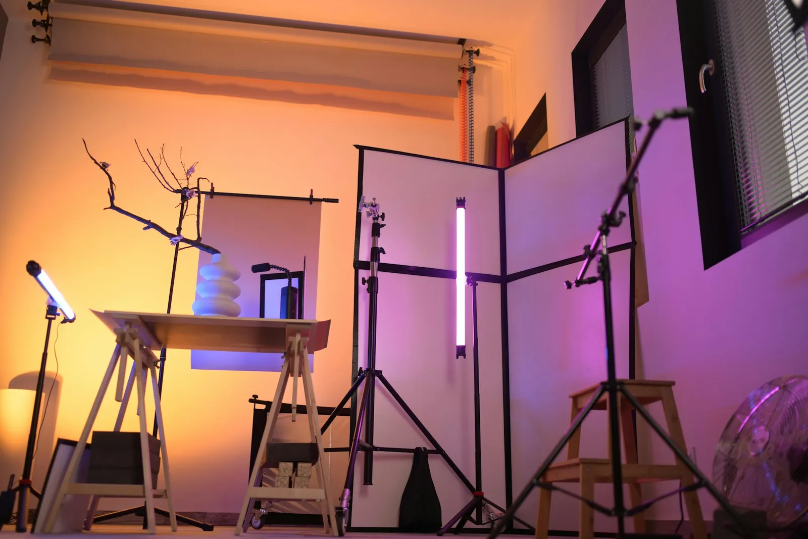 A small product photography studio setup with lights and a backdrop